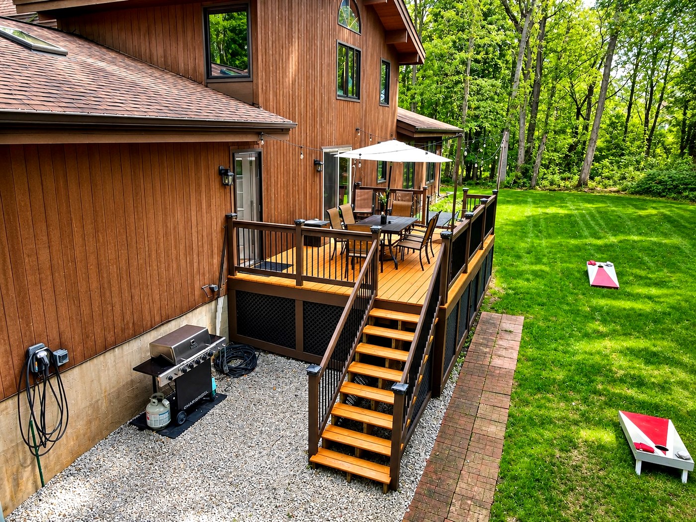 Deck with outdoor dining, gas grill and cornhole